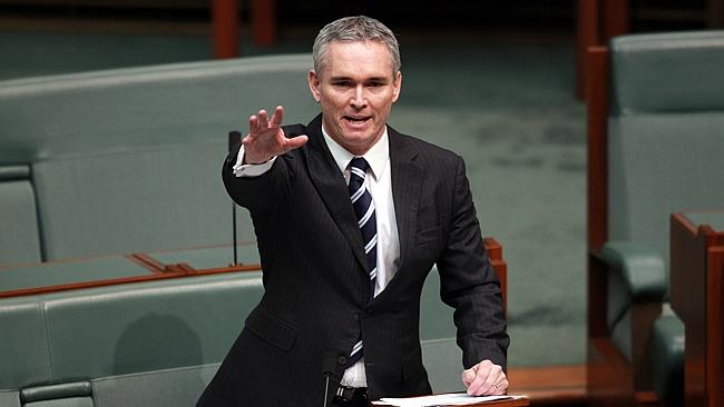 Thomson gestures towards the media during his address