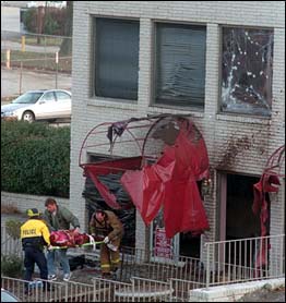 A body is pulled out of a bombed clinic after a Christian terrorist attack
